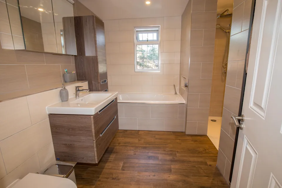 Loft bathroom with bath and wooden flooring