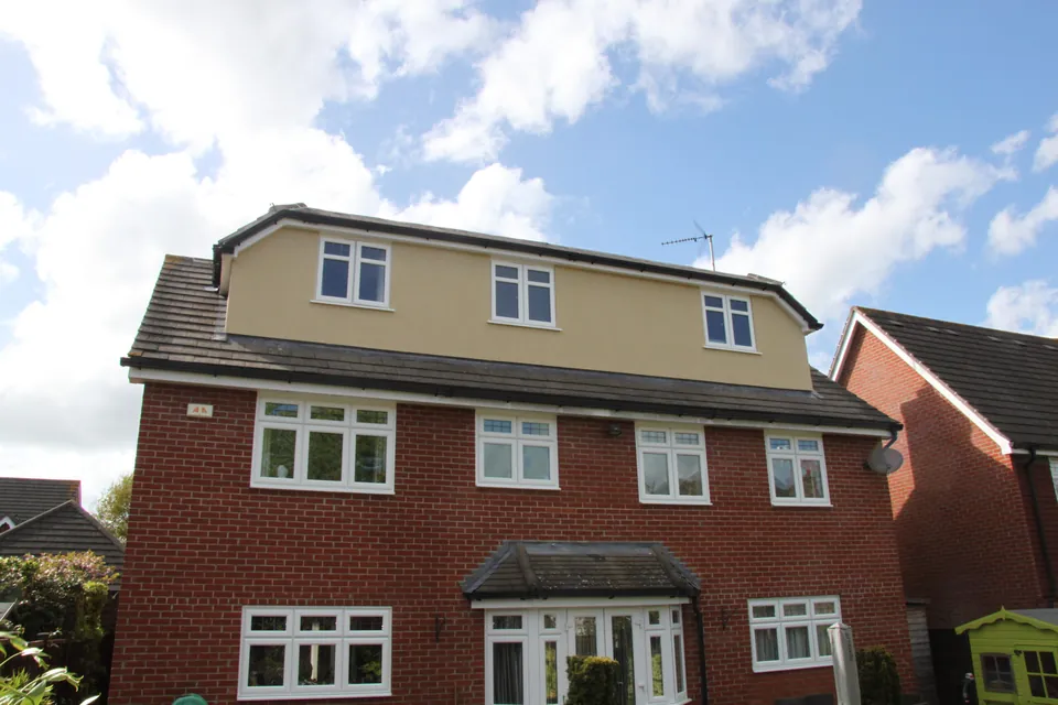 Large brick family home in Essex with a rendered rear dormer conversion in the roof